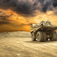 Copper mining haul truck transporting ore in open-pit operation to supply flotation and hydrometallurgical processing circuits.