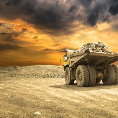 Copper mining haul truck transporting ore in open-pit operation to supply flotation and hydrometallurgical processing circuits.
