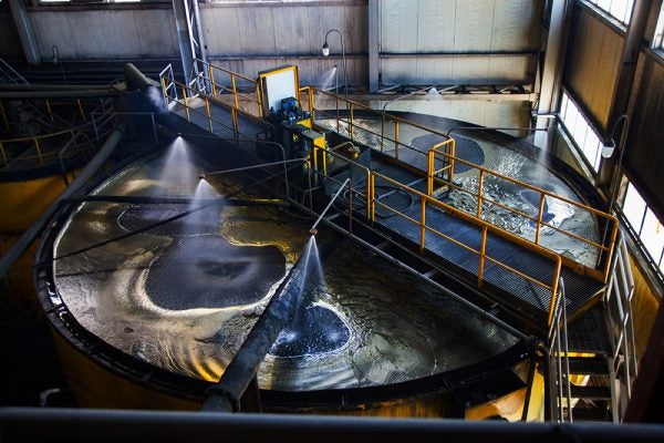 Industrial mining tank with controlled foam in flotation and clarification circuit.