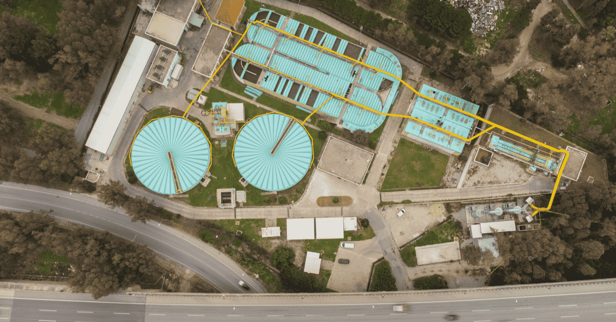 Aerial photo of water treatment facility showing clarifiers and treatment tanks